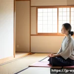사례 연구  용서를 통한 치유 경험 - A serene Japanese woman in modern casual clothes sitting peacefully in a minimalist tatami room, sun...